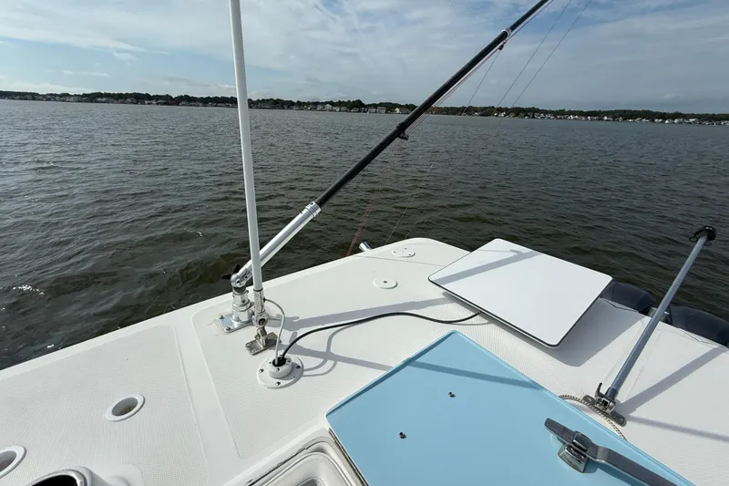 Slide: The Image of 2018 SeaHunter 35 Tournament boat deck with fishing rod setup on calm waters. - 106