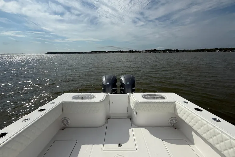 Slide: The Image of 2018 SeaHunter 35 Tournament boat on open water, featuring dual engines and spacious deck. - 17