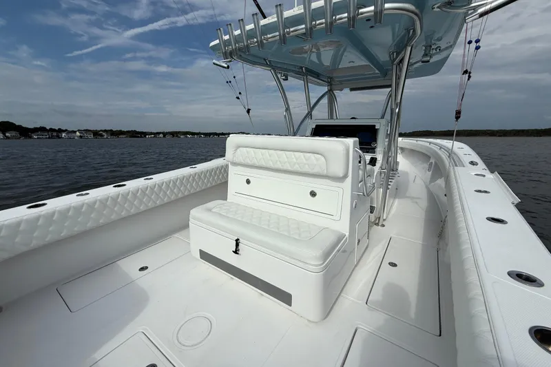 Slide: The Image of 2018 SeaHunter 35 Tournament boat interior with white seating and fishing rod holders. - 25