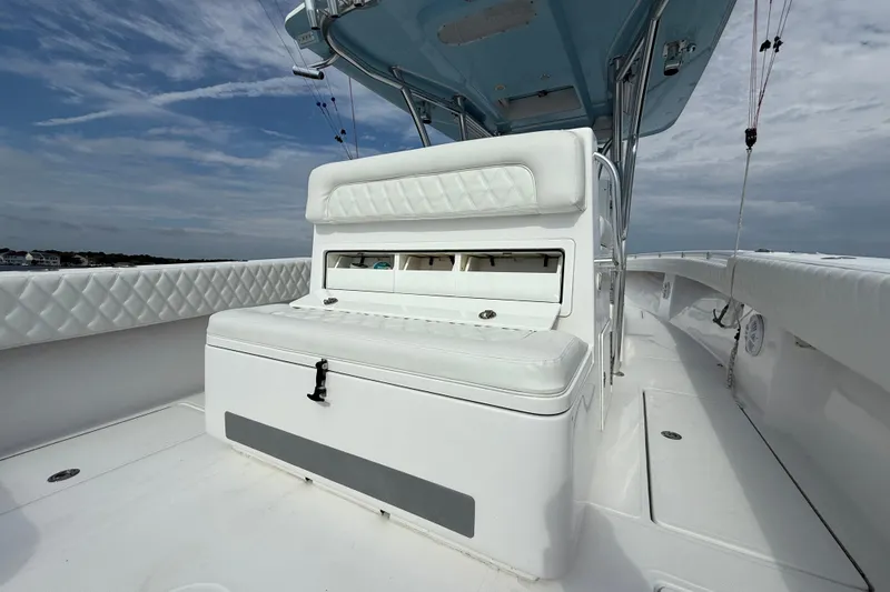Slide: The Image of 2018 SeaHunter 35 Tournament boat interior with white seating and storage compartments. - 26