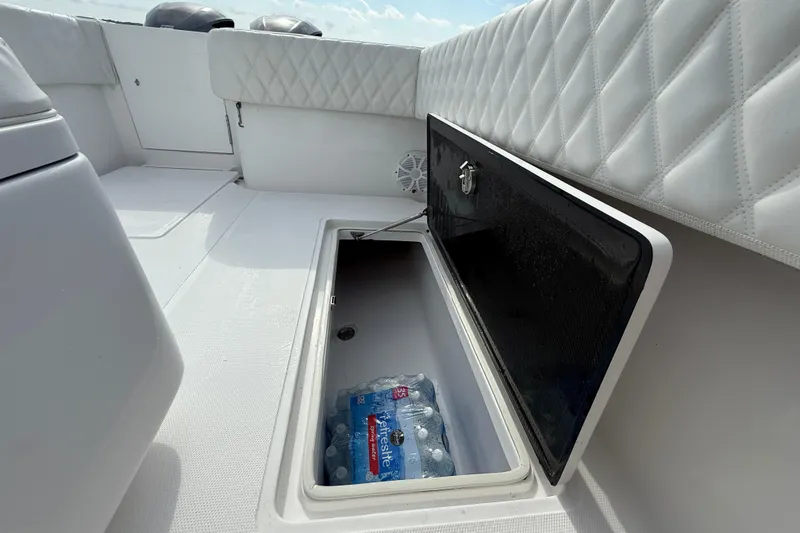Slide: The Image of 2018 SeaHunter 35 Tournament boat with open storage compartment containing bottled water. - 30