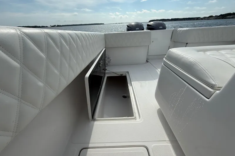 Slide: The Image of 2018 SeaHunter 35 Tournament boat interior with white seating and open storage compartment. - 34