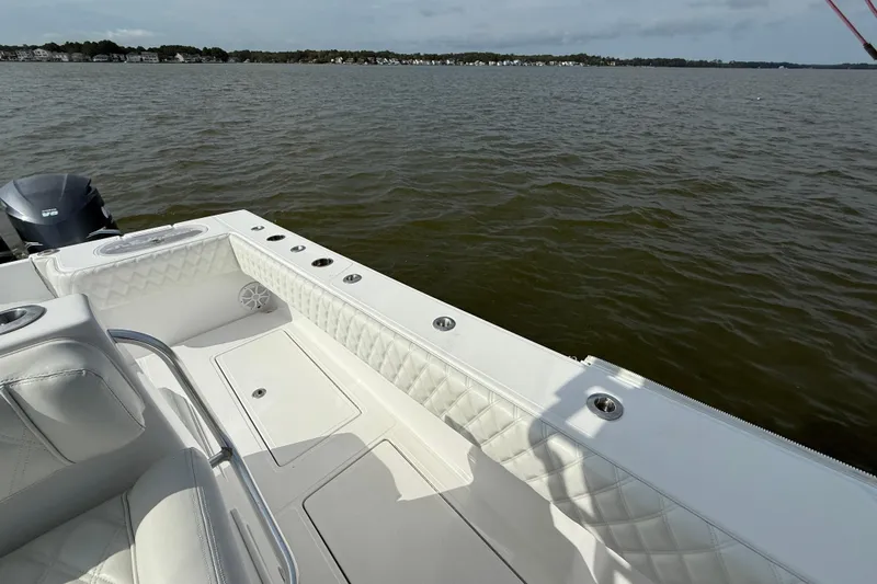 Slide: The Image of 2018 SeaHunter 35 Tournament boat interior with white seating on calm water. - 40