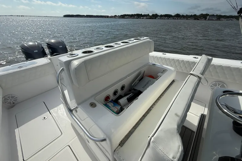 Slide: The Image of 2018 SeaHunter 35 Tournament boat interior with storage and twin engines on a sunny day. - 44