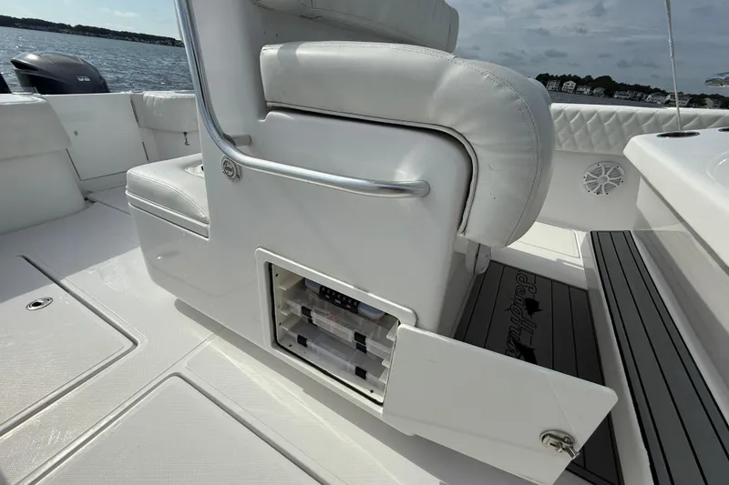 Slide: The Image of 2018 SeaHunter 35 Tournament boat interior with storage compartment open, showcasing seating and deck details. - 45