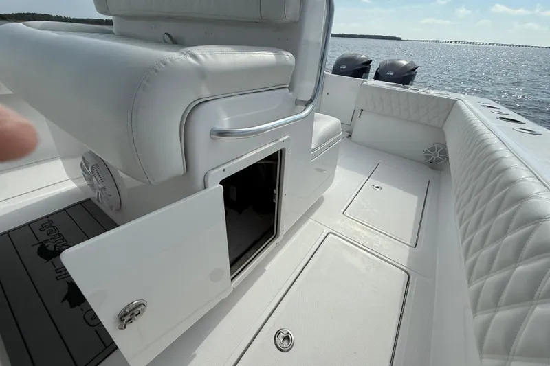Slide: The Image of 2018 SeaHunter 35 Tournament boat interior with open storage, white seating, and ocean view. - 47
