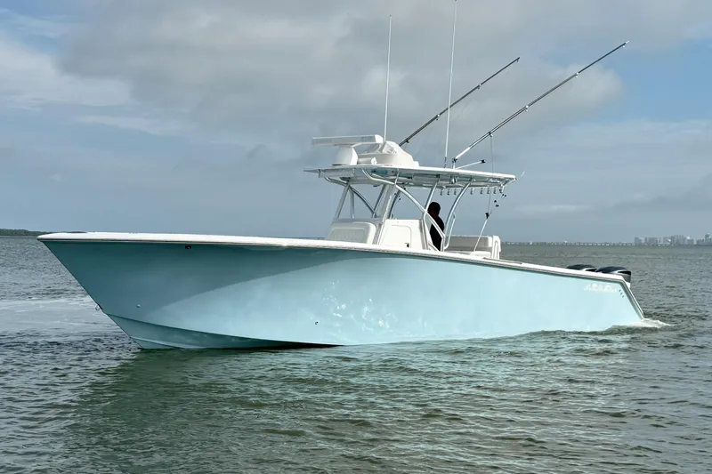 Slide: The Image of 2018 SeaHunter 35 Tournament boat on calm water, overcast sky. - 5