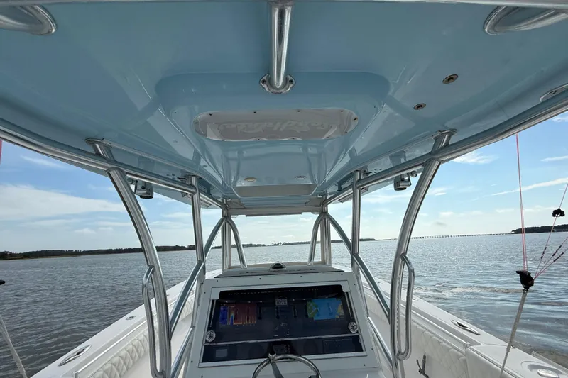 Slide: The Image of 2018 SeaHunter 35 Tournament boat interior with navigation system, cruising on calm waters. - 50