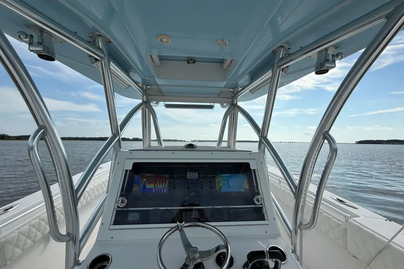 Slide: The Image of 2018 SeaHunter 35 Tournament boat cockpit with navigation system, steering wheel, and ocean view. - 51