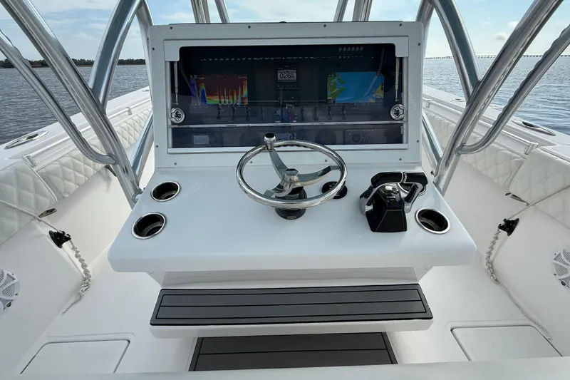 Slide: The Image of 2018 SeaHunter 35 Tournament boat console with steering wheel and navigation display. - 53
