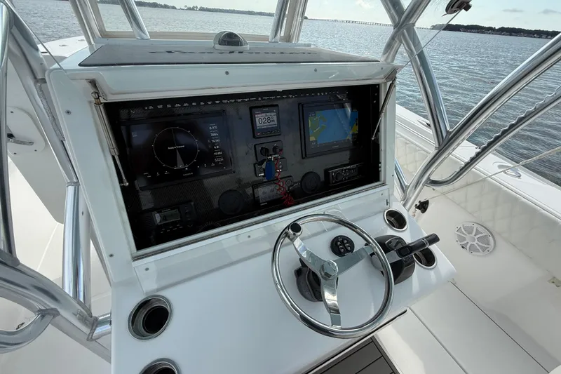 Slide: The Image of 2018 SeaHunter 35 Tournament boat dashboard with navigation screens and steering wheel. - 54