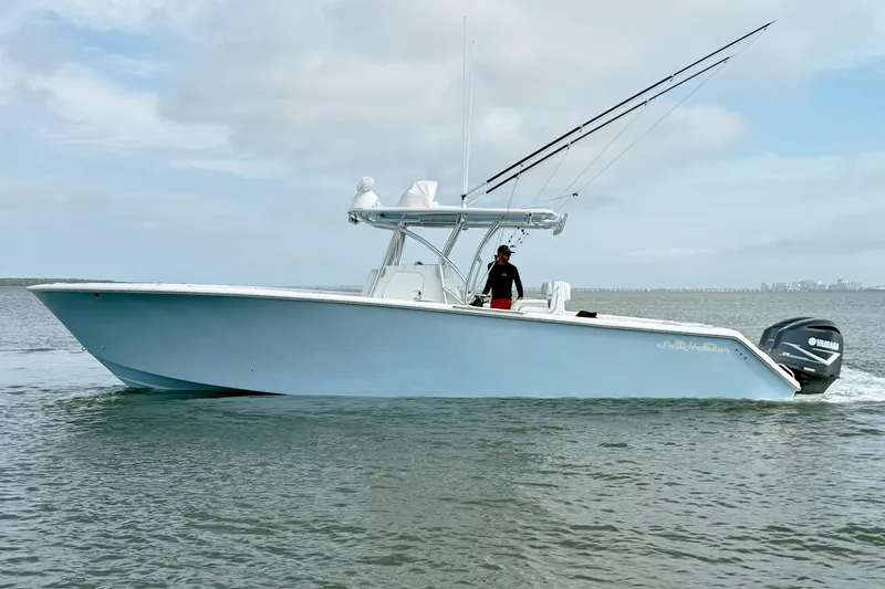 Slide: The Image of 2018 SeaHunter 35 Tournament boat cruising on calm waters under a cloudy sky. - 6