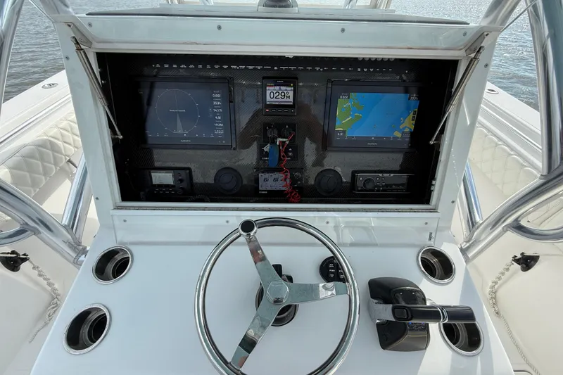 Slide: The Image of 2018 SeaHunter 35 Tournament boat dashboard with navigation screens and steering wheel. - 62