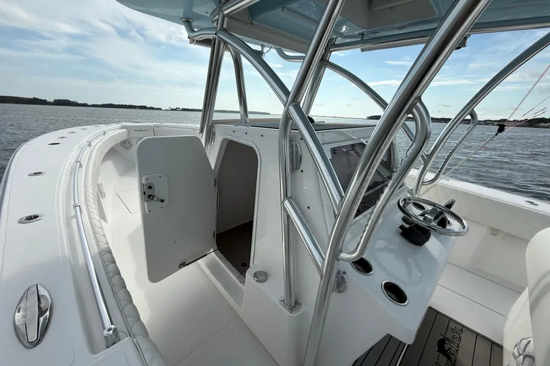 Slide: The Image of 2018 SeaHunter 35 Tournament boat interior with open cabin door and steering console. - 63