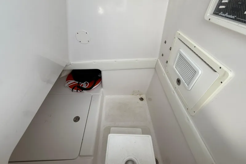 Slide: The Image of 2018 SeaHunter 35 Tournament boat interior with storage compartment and life preserver. - 64