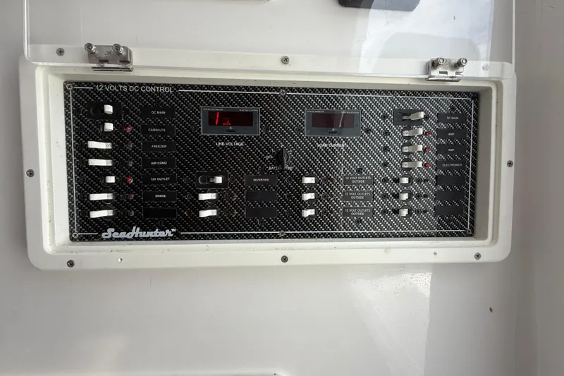 Slide: The Image of Control panel of a 2018 SeaHunter 35 Tournament boat, featuring 12 volts DC system. - 66