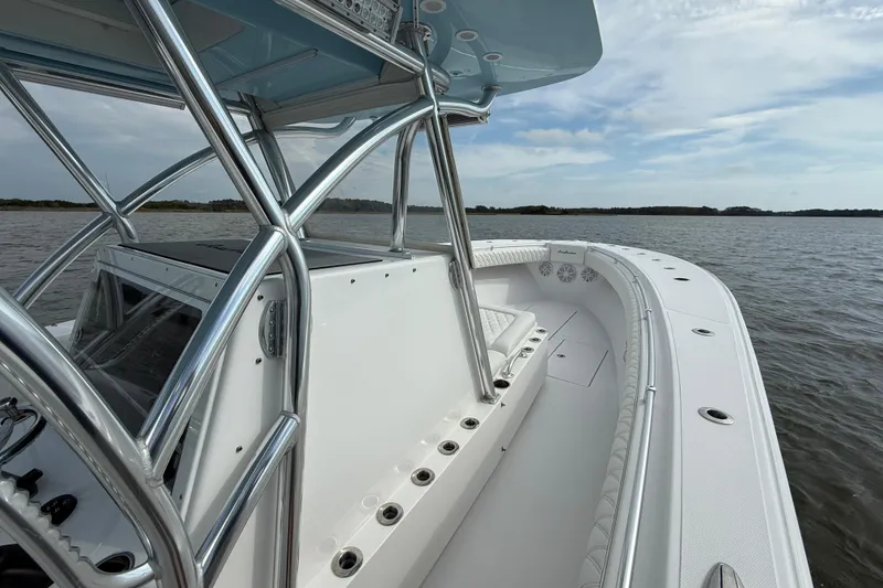 Slide: The Image of 2018 SeaHunter 35 Tournament boat on calm waters, showcasing sleek design and spacious deck. - 73