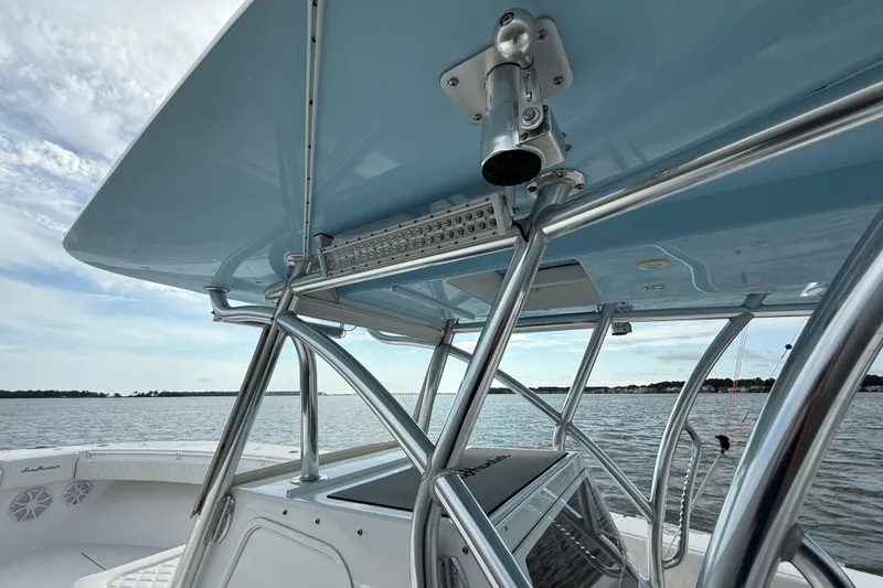 Slide: The Image of 2018 SeaHunter 35 Tournament boat with sleek T-top and rod holders on open water. - 74