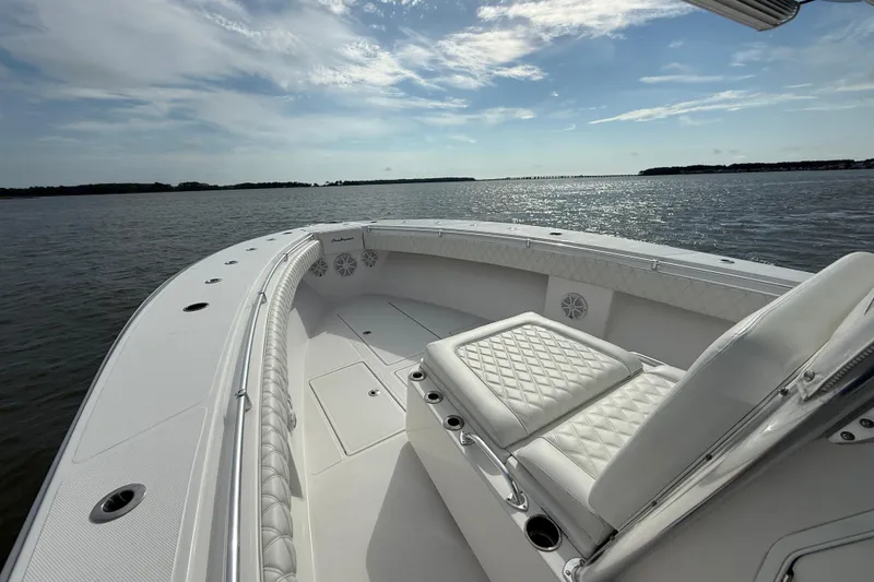 Slide: The Image of 2018 SeaHunter 35 Tournament boat on calm water, featuring luxurious seating and clear skies. - 76