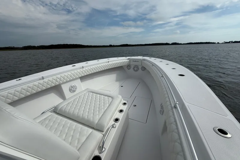 Slide: The Image of 2018 SeaHunter 35 Tournament boat with white seating on calm water. - 77