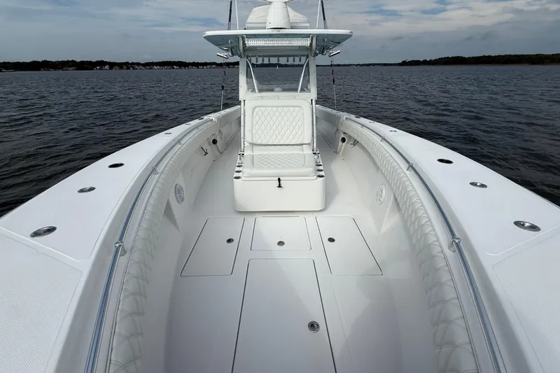 Slide: The Image of 2018 SeaHunter 35 Tournament boat on calm water, showcasing spacious deck and seating. - 78
