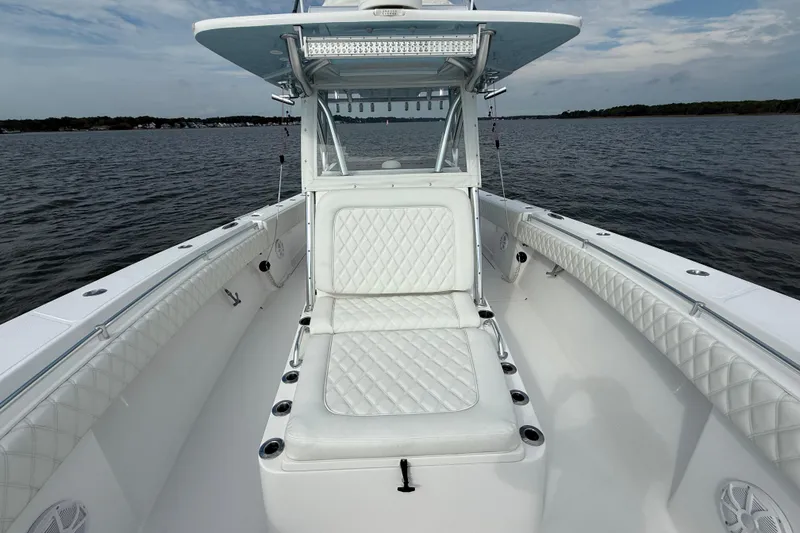 Slide: The Image of 2018 SeaHunter 35 Tournament boat with white cushioned seating on open water. - 79