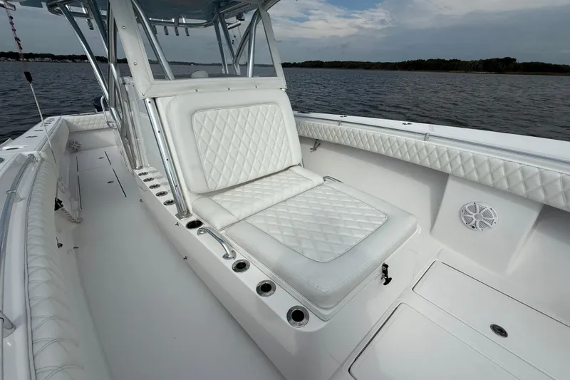 Slide: The Image of 2018 SeaHunter 35 Tournament boat interior with white quilted seating on calm water. - 84