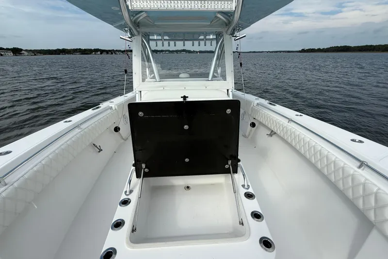 Slide: The Image of 2018 SeaHunter 35 Tournament boat on calm water, showcasing spacious deck and seating. - 85