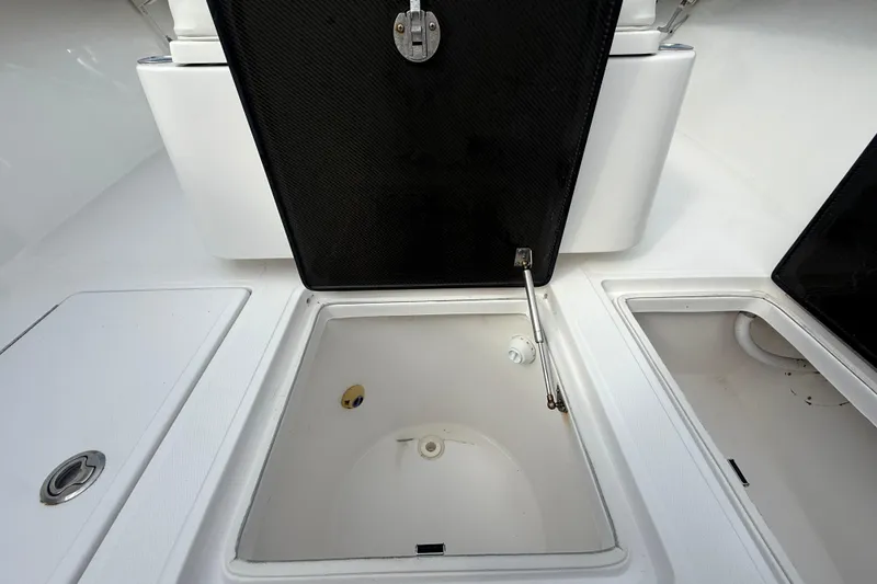 Slide: The Image of Open storage compartments on a 2018 SeaHunter 35 Tournament boat deck. - 87