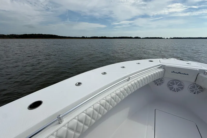 Slide: The Image of 2018 SeaHunter 35 Tournament boat on calm water under a partly cloudy sky. - 95