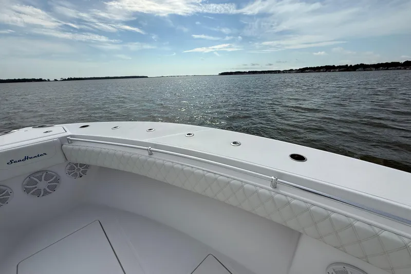 Slide: The Image of 2018 SeaHunter 35 Tournament boat on calm waters under a partly cloudy sky. - 96
