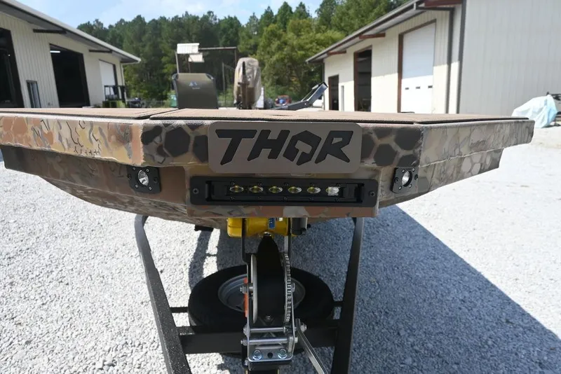 Slide: The Image of Camouflage Thor 1754 boat, 2026 model, on trailer in outdoor setting. - 4