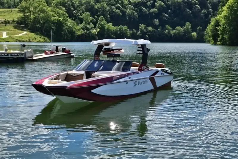 Slide: The Image of 2025 Varatti Z2373 boat on a serene lake with lush green surroundings. - 5