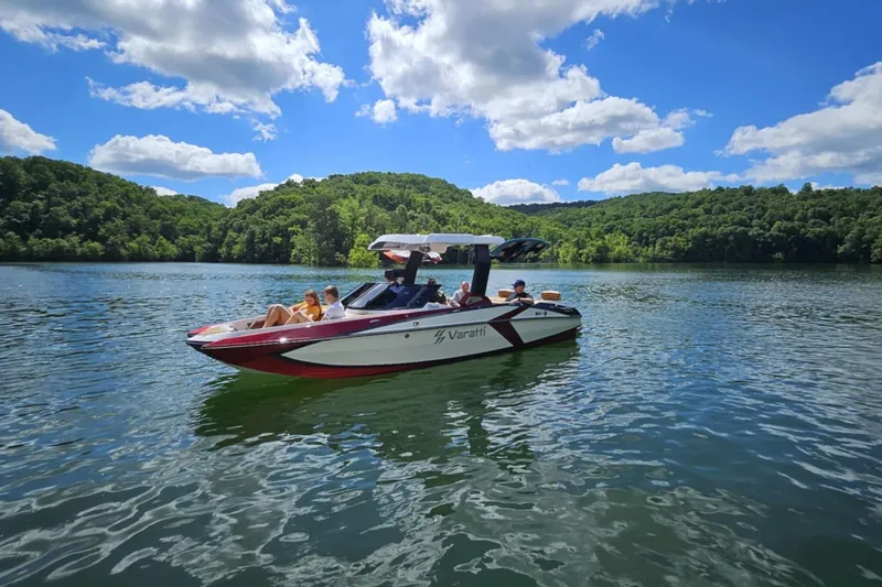 Slide: The Image of 2025 Varatti Z2373 boat cruising on a scenic lake under a clear blue sky. - 7