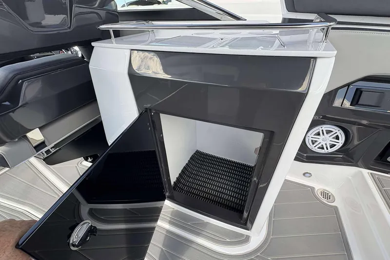 Slide: The Image of 2026 Monterey 275SS Super Sport boat interior with open storage compartment and speaker. - 15