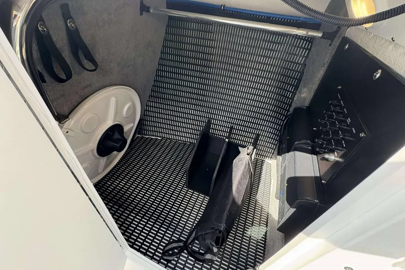 Slide: The Image of Interior storage compartment of 2026 Monterey 275SS Super Sport boat, featuring organized space and controls. - 22