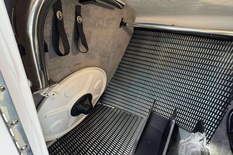 Slide: The Image of Interior of 2026 Monterey 275SS Super Sport boat, featuring storage area and safety equipment. - 24