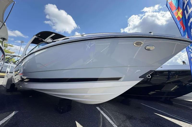 Slide: The Image of 2026 Monterey 275SS Super Sport boat displayed outdoors under a blue sky. - 5