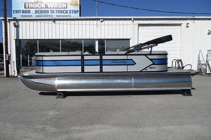The Image of 2026 Bentley Pontoons 223 Bolt pontoon boat parked outside a truck wash facility. - 1
