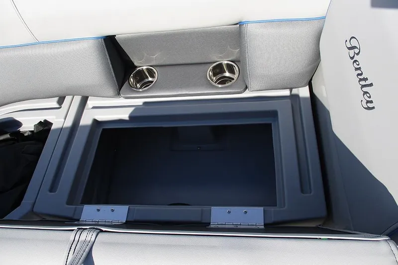 Slide: The Image of 2026 Bentley Pontoons 223 Bolt interior storage compartment with cup holders and logo. - 13