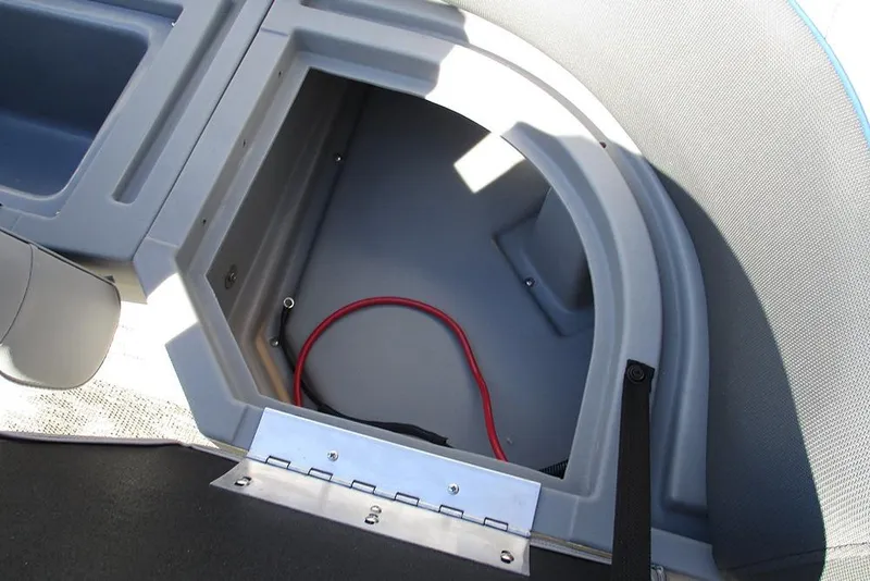 Slide: The Image of Open storage compartment in 2026 Bentley Pontoons 223 Bolt boat, featuring a red cable. - 28
