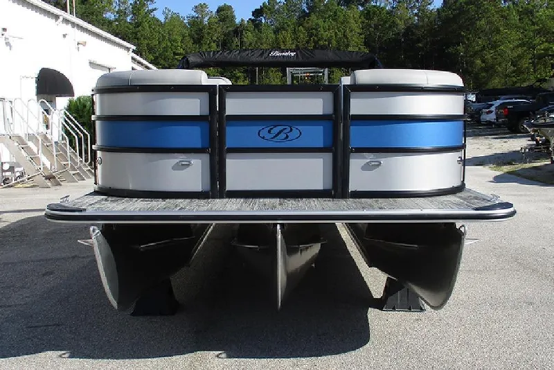 Slide: The Image of 2026 Bentley Pontoons 223 Bolt, front view, parked outdoors with trees in background. - 4