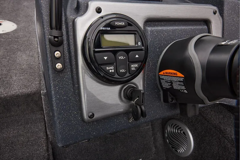 Slide: The Image of Manufacturer Provided Image: Control panel of 2026 Tracker Pro Guide V-175 WT boat with audio system and warning label. - 28