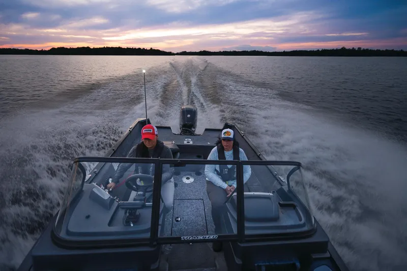 Slide: The Image of Manufacturer Provided Image: 2026 Tracker Pro Guide V-175 WT boat cruising on a lake at sunset. - 49