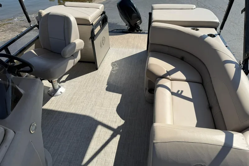 Slide: The Image of 2018 Avalon GS Cruise II boat interior with beige seating and helm chair. - 10