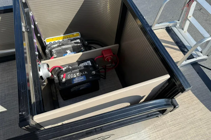 Slide: The Image of Battery compartment of 2018 Avalon GS Cruise II pontoon boat, featuring dual batteries. - 12