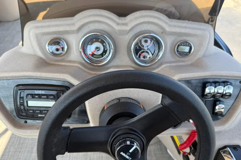 Slide: The Image of Dashboard of 2018 Avalon GS Cruise II boat with steering wheel and gauges. - 13