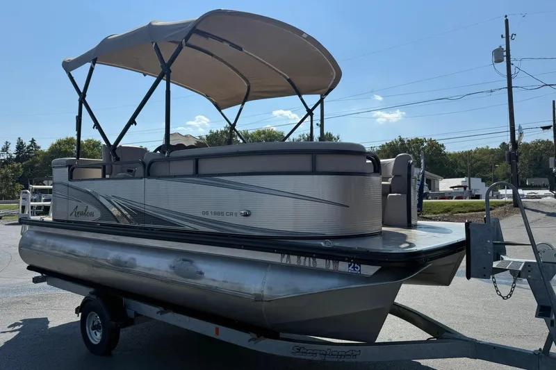 Slide: The Image of 2018 Avalon GS Cruise II 19' pontoon boat on trailer, featuring canopy and sleek design. - 6