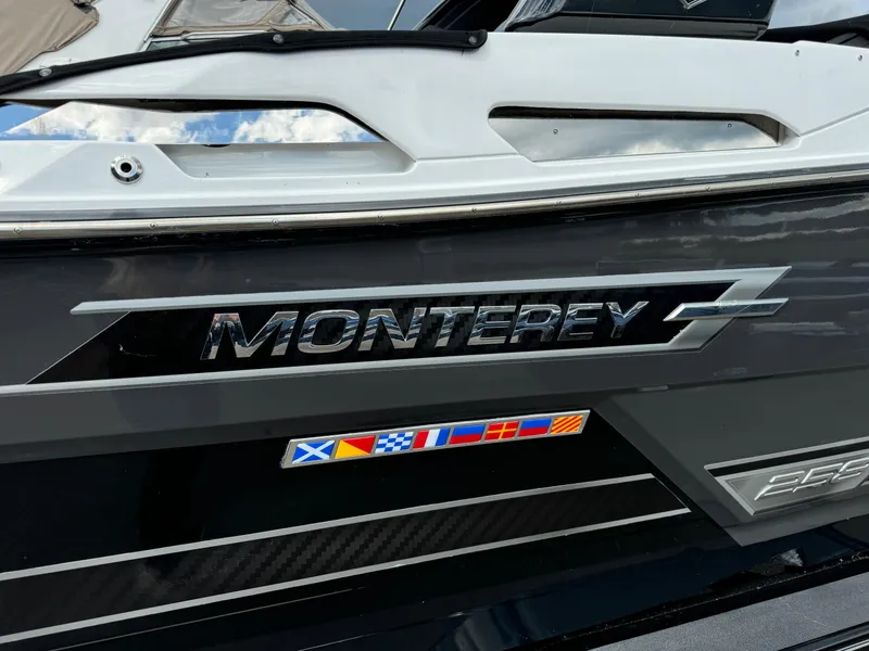 Slide: The Image of 2022 Monterey 258 Super Sport boat with logo and nautical flags. - 2