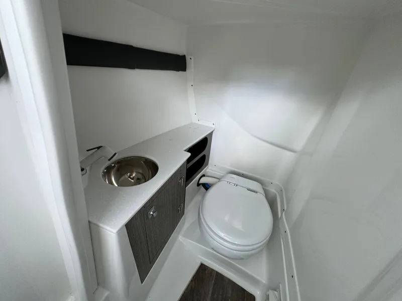 Slide: The Image of 2022 Monterey 258 Super Sport boat interior with compact bathroom and sink. - 20
